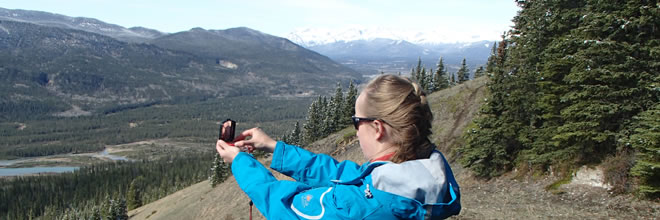 Taking a Compass Bearing on a Navigation Course in the Mountians