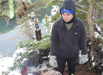 Trina tending her Fire, note the drop to the Lake below