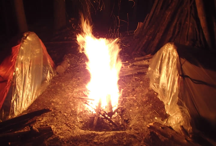 Double Super Shelters at a Survival Camp with Fire