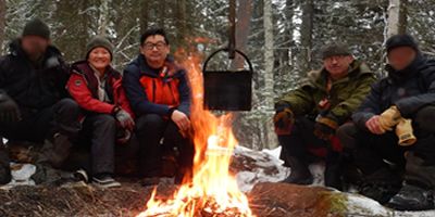 Group Melting Snow with a Cooking Fire